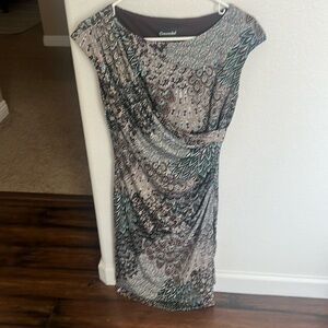 Beautifully fitting dress with drape front.